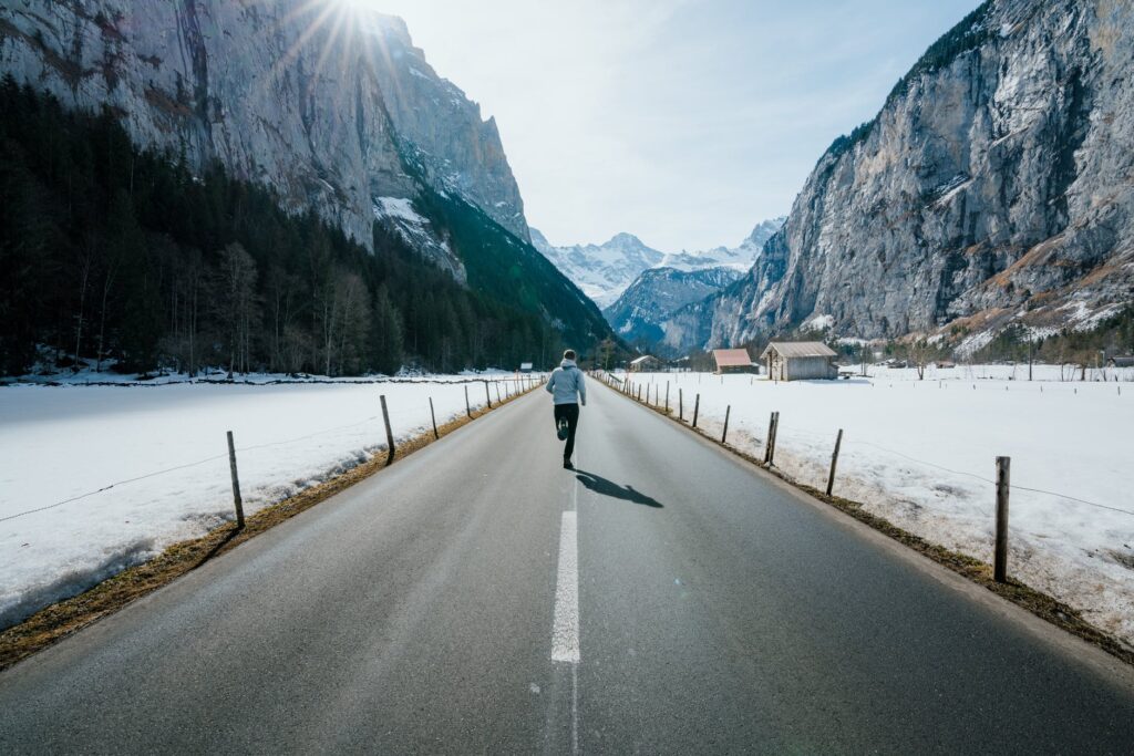 person jogging on road